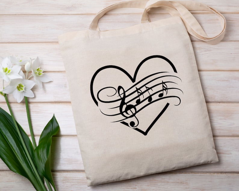 May include: A white canvas tote bag with a black heart design featuring musical notes and a treble clef. The heart is outlined in black and the musical notes are stylized.