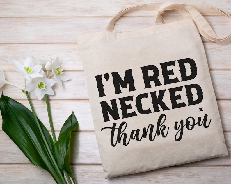 以下が含まれることがあります： 黒い文字で「I'm Red Necked, thank you」と書かれた白いキャンバス地のトートバッグです。