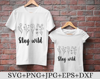 May include: Two white t-shirts with black floral designs and the text "Stay Wild".