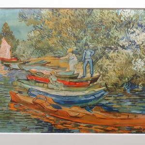 May include: A painting of a river scene with several boats docked along the shore. The boats are painted in various shades of blue, green, and red. Two figures stand on the shore, one in a blue dress and the other in a blue shirt and pants. The background is a lush green forest.