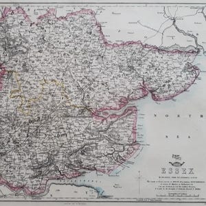 May include: An antique map of Essex, England, with detailed cartography. The map features a pink border and is labeled "ESSEX" in the lower right corner. The map is printed on aged paper, showing signs of wear.
