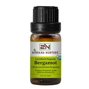 May include: A small amber glass bottle of Nirvana Nurture Certified Organic Bergamot essential oil. The label includes the brand name, product name, and other details. The bottle contains 1/3 FL OZ (10mL) of oil.