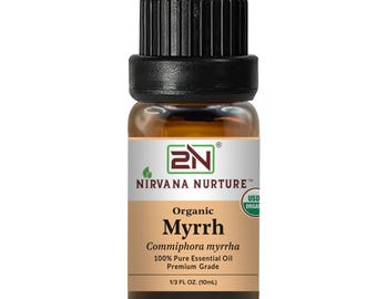 May include: A small glass bottle of organic myrrh essential oil. The bottle has a black cap and a label with the text "Nirvana Nurture" and "Myrrh". The bottle contains 10ml of oil.