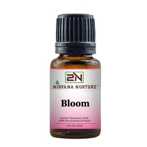 May include: An amber glass bottle of essential oil with a black cap. The label reads "NIRVANA NURTURE Bloom" and "Premium Therapeutic Grade 100% Pure Essential Oil Blend 1/3 FL OZ. (10mL)." The bottle is on a white background.