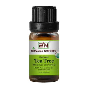 May include: A small amber glass bottle of organic tea tree essential oil. The label reads "Nirvana Nurture" and "Tea Tree" with the scientific name, and "100% Pure Essential Oil." The bottle contains 1/3 fl oz (10mL).