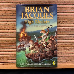 May include: A book cover featuring an illustration of a group of mice on a raft, with a burning building in the background. The title of the book is "High Rhulain" by Brian Jacques. The text "A New Tale of Redwall" is also on the cover. The bottom of the cover reads "Over 10 Million Redwall Books Sold."