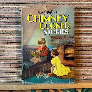 May include: Vintage book cover for "Chimney Corner Stories" by Enid Blyton. The cover features an illustration of two children reading by a fireplace. The title is in large yellow letters with a green glow.