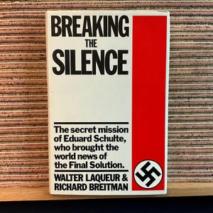 May include: A white book with a red spine and a black swastika symbol on the cover. The title of the book is "Breaking the Silence". The book is about the secret mission of Eduard Schulte, who brought the world news of the Final Solution. The authors are Walter Laqueur and Richard Breitman.