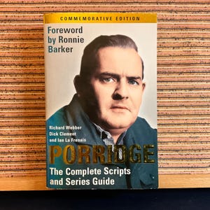 May include: A book cover with a photo of Ronnie Barker, the title "Porridge: The Complete Scripts and Series Guide", and the text "Commemorative Edition".