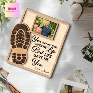 May include: Wooden photo frame with a rectangular photo of a couple, a shoe print, and the text "You may not have given me life but life gave me you. Love, Jessie." The frame is light brown with a natural wood grain.