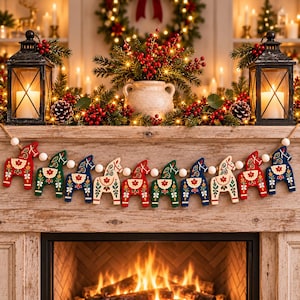 May include: A decorative garland featuring ten wooden Dala horse ornaments in alternating red, green, and blue colors, each painted with intricate floral patterns. The horses are strung together on a cord with small white wooden beads between them.