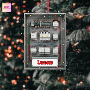 May include: A rectangular Christmas ornament featuring an electrical panel design. The panel is gray with various components, wires, and the name "Lucas" in red. The ornament is decorated with colorful string lights and a red ribbon for hanging.