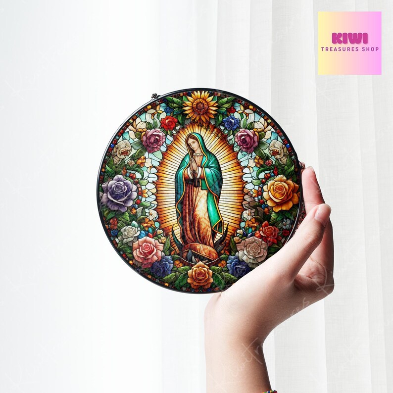 May include: A round stained glass window depicting the Virgin Mary in colourful detail, surrounded by flowers. The window is framed in black metal.