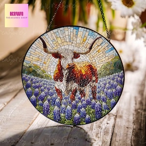 May include: A stained glass window hanging with a mosaic design of a Texas Longhorn steer standing in a field of bluebonnets. The steer is brown and white with long horns. The background is a mosaic of yellow, blue, and green.