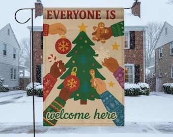 May include: A decorative garden flag with the text "EVERYONE IS welcome here." The flag features a green Christmas tree, ornaments, gingerbread men, and hands of various skin tones. The background is a winter scene with snow.