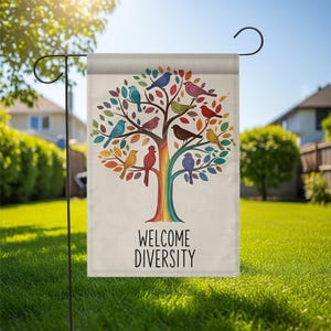 May include: A garden flag featuring a colorful tree with birds of various colors perched on its branches. The tree has a rainbow trunk and leaves in shades of red, orange, yellow, and green. The text "WELCOME DIVERSITY" is printed below the tree.