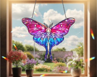 May include: A stained glass butterfly suncatcher with a vibrant design of pink, purple, and blue. The butterfly is suspended by a silver chain, and the background shows a window with a garden view.