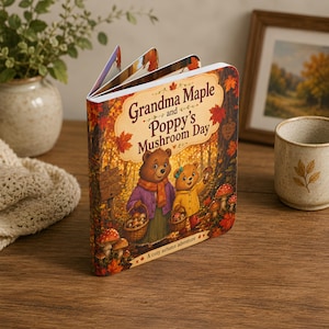 May include: A children's board book titled Grandma Maple and Poppy's Mushroom Day with a cover illustration of two bears in a forest gathering mushrooms. The cover features warm autumn colors, red maple leaves, and the text A cozy autumn adventure.