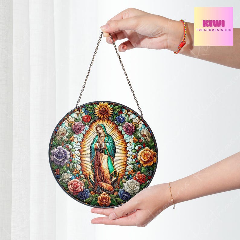 May include: A round stained glass window hanging from a chain. The window features a colourful image of the Virgin Mary surrounded by flowers.