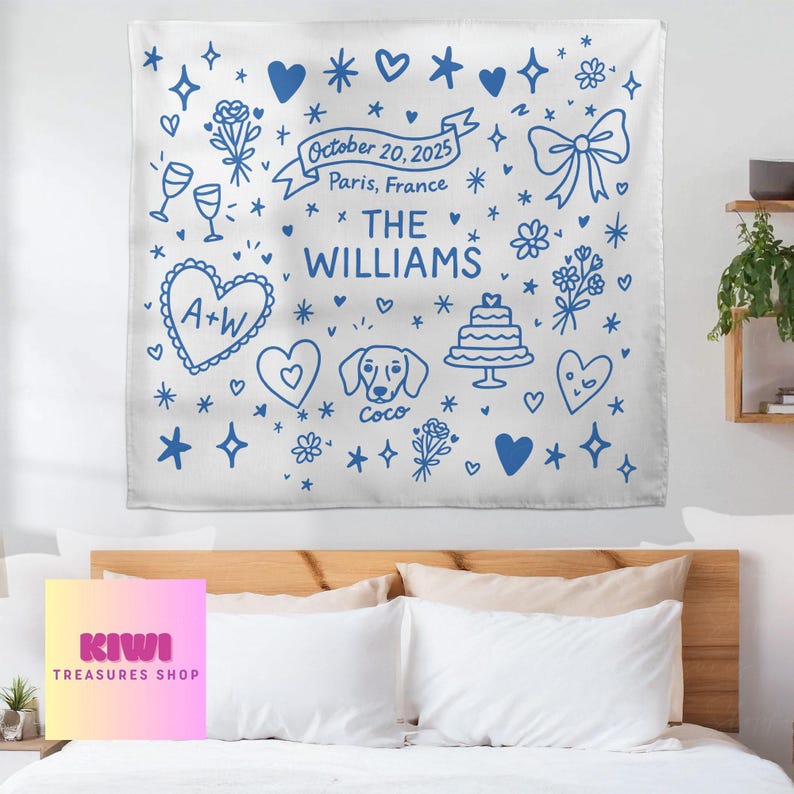 May include: White tapestry with blue illustrations, including hearts, flowers, and a cake. Text reads "October 20, 2025, Paris, France, The Williams." Features a dog illustration and the initials "A+W."