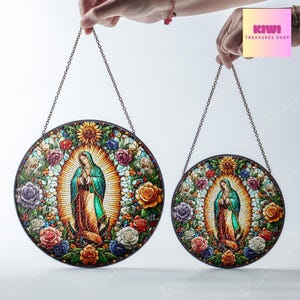 May include: Two round stained glass window hangings featuring a depiction of the Virgin Mary surrounded by colourful flowers. The larger hanging is 12 inches in diameter and the smaller hanging is 8 inches in diameter.