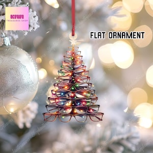 May include: A flat Christmas tree ornament made from eyeglasses, with a red ribbon for hanging. The tree is decorated with colorful lights. The text "FLAT ORNAMENT" is displayed on the right side of the image.