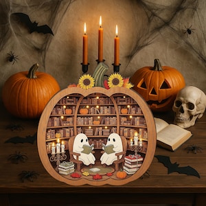 May include: A Halloween-themed wooden pumpkin bookshelf with two ghost figures reading books. The bookshelf is surrounded by pumpkins, candles, a skull, and spiderwebs. The scene is decorated with bats and spiders.