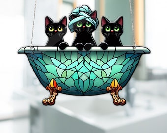 May include: Three black cats wearing towels sit in a turquoise stained glass bathtub with gold feet.