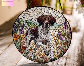 May include: A stained glass suncatcher featuring a brown and white German Shorthaired Pointer dog walking through a field of flowers. The suncatcher is round and has a mosaic design.