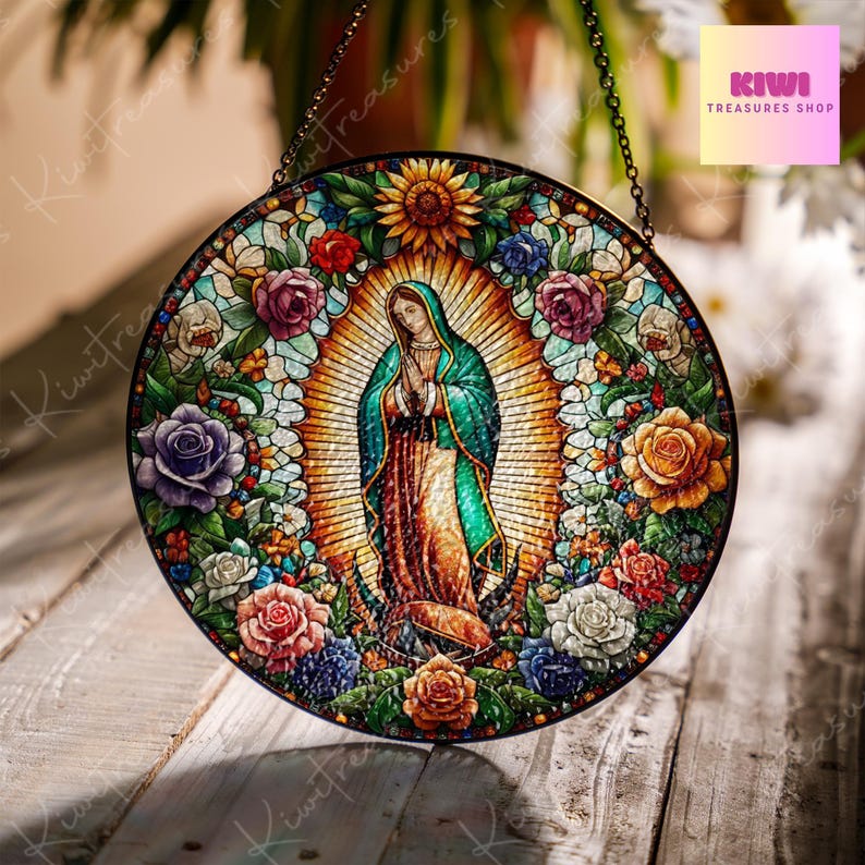 May include: A stained glass window hanging with a depiction of the Virgin Mary surrounded by colourful flowers and a sunflower. The image is set against a gold background with a halo around the Virgin Mary.