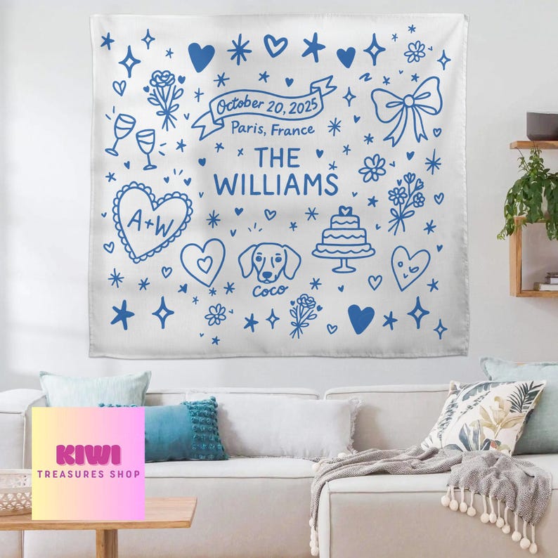 May include: White wall tapestry with blue illustrations of hearts, flowers, and a cake. Text includes "October 20, 2025, Paris, France" and "THE WILLIAMS". Features a heart with "A+W" and a dog named "Coco".