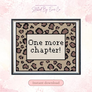 May include: A framed cross stitch pattern featuring a beige and brown leopard print background with a central white rectangular block containing the black text One more chapter! The design is presented as a digital needlepoint and cross stitch guide.