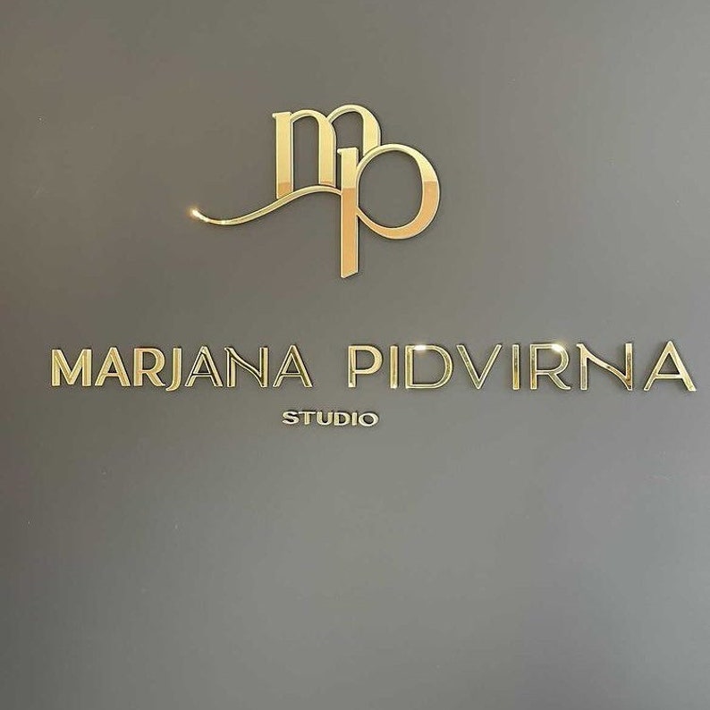 May include: Gold logo with the letters "MP" intertwined and the text "MARJANA PIDVIRNA STUDIO" below.