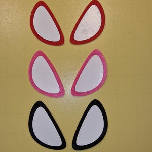 May include: Three pairs of felt spider eyes in red, pink, and black. Each pair is made of two individual eyes.