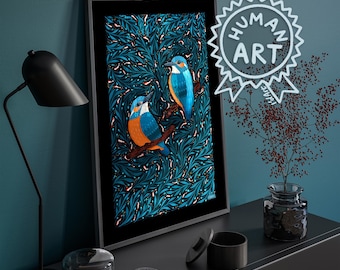 May include: A framed vertical art print featuring two blue and orange kingfisher birds perched on branches against a dense, dark teal foliage pattern. A white circular emblem with the text HUMAN ART is overlaid on the upper right corner.
