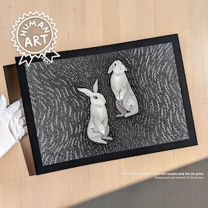 May include: A rectangular art print featuring two white rabbits illustrated with intricate line work against a dense, dark background of swirling white botanical patterns. The print is encased in a simple black border, showcasing a high-contrast design.