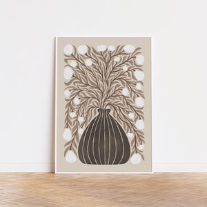 May include: A framed art print featuring a stylized illustration of a vase with a floral arrangement. The vase is dark brown with vertical lines, and the flowers are white with brown leaves against a beige background. The artwork is displayed on a white wall.