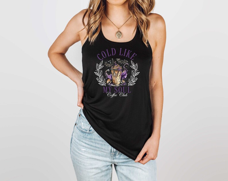 May include: Black tank top with a purple graphic that says "Cold Like My Soul Coffee Club" and features a coffee cup with bats and skulls.