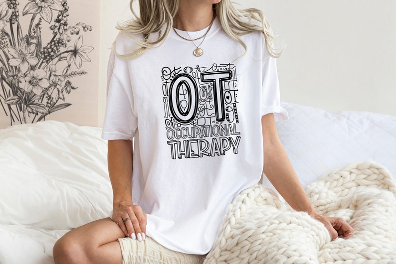 May include: White t-shirt with a black and white graphic design that says "OT Occupational Therapy".