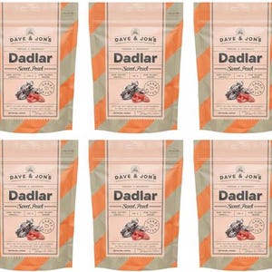 May include: Six packets of "Dadlar Sweet Peach" candy dates. Each packet has a peach-coloured background with diagonal orange stripes. The brand name "Dave & Jon's" is at the top, and the product name is in bold, black letters.