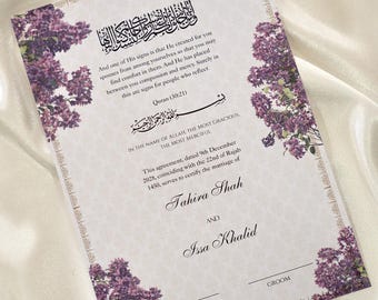 May include: A wedding invitation with floral accents. The invitation features text in both English and Arabic, with the names Tahira Shah and Issa Khalid. The design includes purple floral arrangements.
