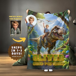 May include: A personalized kids blanket featuring a vibrant illustration of a child riding a Tyrannosaurus Rex in a jungle setting. The blanket includes the name "OLIVER" and the phrase "MISSION: T-REX TAKEOVER". Additional text reads "FANTASY WORLD KIDS BLANKETS" and "High Quality".