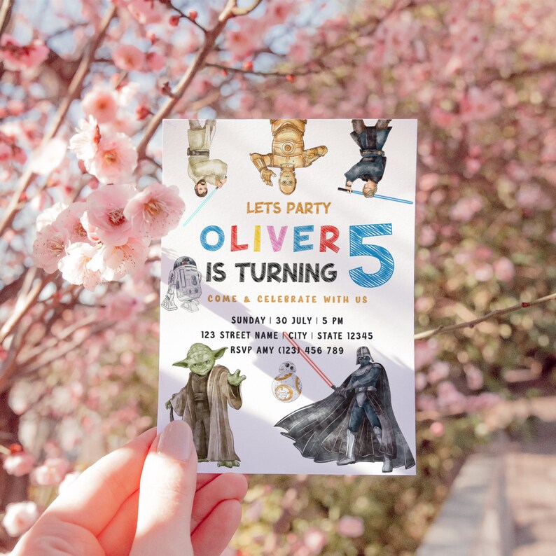May include: A white invitation card with a Star Wars theme. The card features illustrations of characters from the Star Wars movies, including Yoda, Darth Vader, R2-D2, and C-3PO. The text on the card reads "Let's Party Oliver is turning 5 Come & Celebrate with us Sunday | 30 July | 5 PM 123 Street Name City | State 12345 RSVP Amy (123) 456 789".
