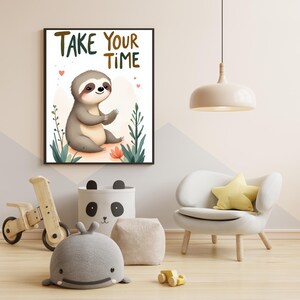 May include: A framed print with a cartoon sloth illustration and the text "TAKE YOUR TIME". The sloth is gray and tan, surrounded by plants and flowers. The print is in a child's room with a wooden toy bike and a panda-themed storage bin.