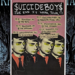 May include: A poster for the $uicideboy$ tour, featuring four stylized portraits with yellow accents. The poster has a pink background with tour dates and locations listed in black text, including Raleigh, Richmond, Washington, Philadelphia, Providence, Queens, and Santa Ana.