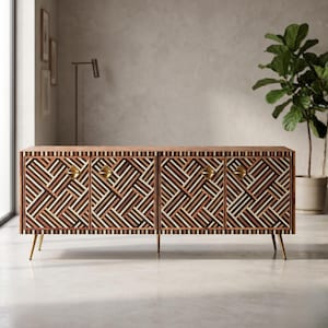 May include: A rectangular wooden sideboard featuring four cabinet doors with a complex geometric pattern of dark brown, light brown, and white stripes. The unit is supported by four slender, tapered gold-toned metal legs and has small gold-toned diamond-shaped knobs.
