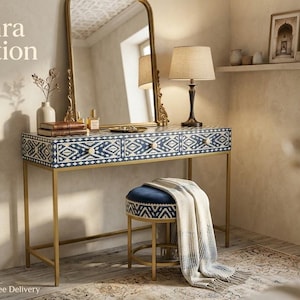 May include: A dressing table with a gold frame and a blue and white patterned drawer front. A matching stool with a blue cushion and a patterned base sits in front of the table. A gold-framed mirror and a lamp are on the table. The text "Rudhra Creation" is in the image.