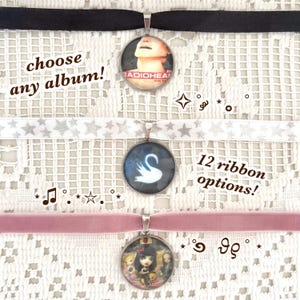 May include: Chokers with round pendants featuring album art and other designs, on black, white star, and pink velvet ribbons. The image includes the text "choose any album!" and "12 ribbon options!"