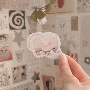 May include: Pink roller skate sticker with the text "Life's so fun, life's so fun".