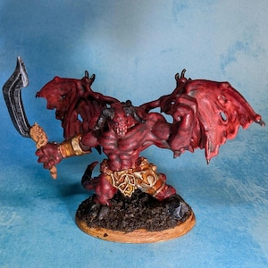 May include: A red painted miniature demon figure with wings, holding a black sword. The figure is standing on a brown base.